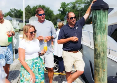 General Manager Wyatt Lane celebrates a boat christening with Bluewater customers