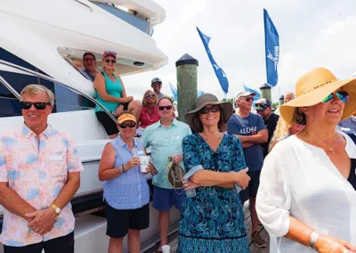 Customers standing around as more new customers christen their boat