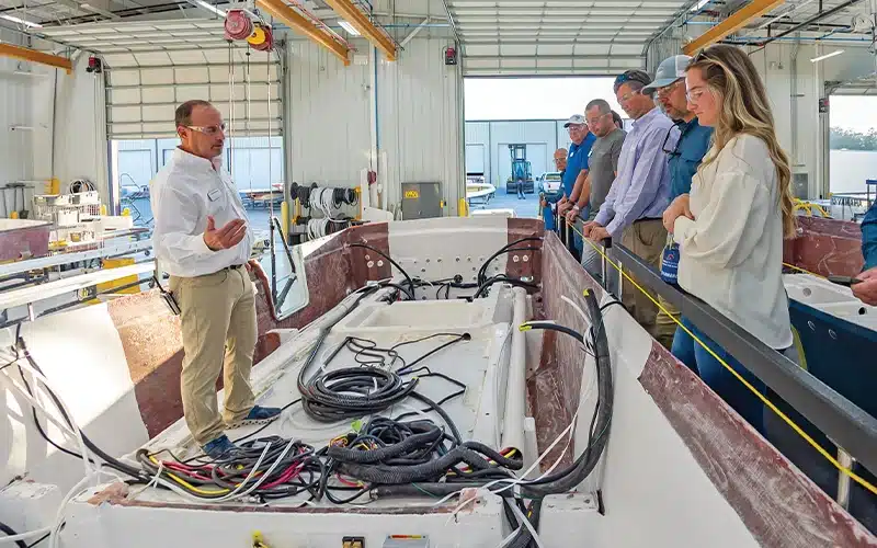 Bluewater team members listen in as they learn about wiring systems on a Regulator boat