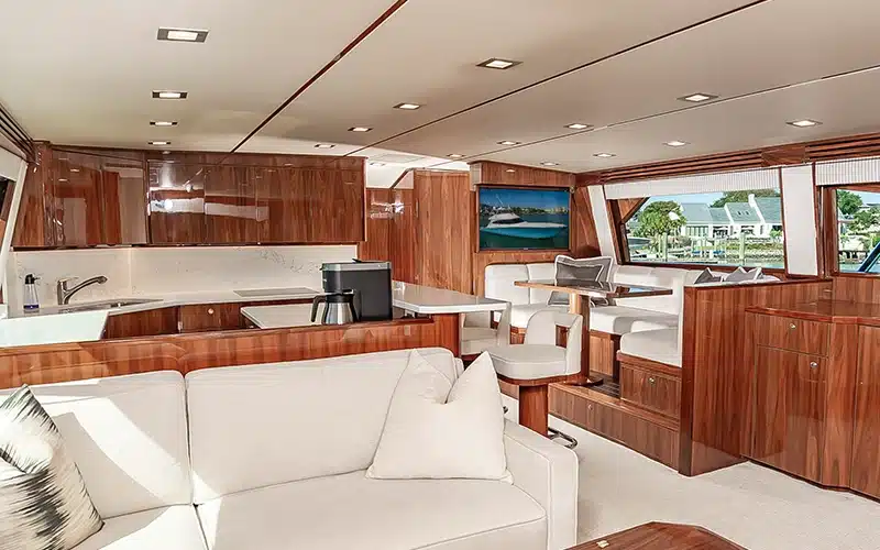 Luxury yacht interior with a modern kitchen, living space, and seating areas designed by Bluewater Yacht Sales