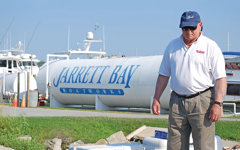 Jack Huddle standing in front of Jarrett Bay's on site fuel tank