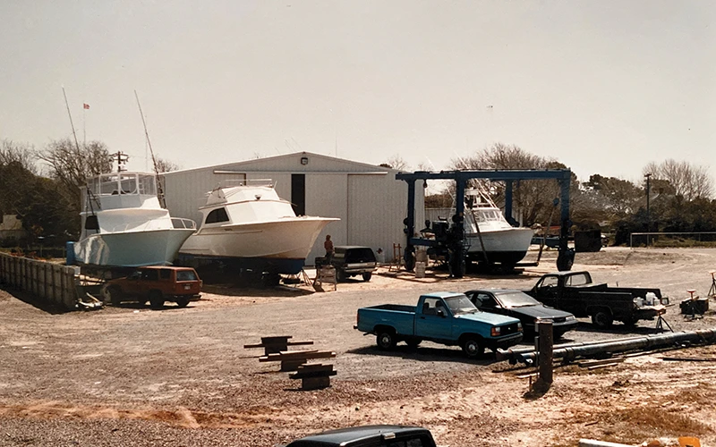 Jarrett Bay’s early boatyard, featuring multiple custom sportfish boats in various stages of construction and repair